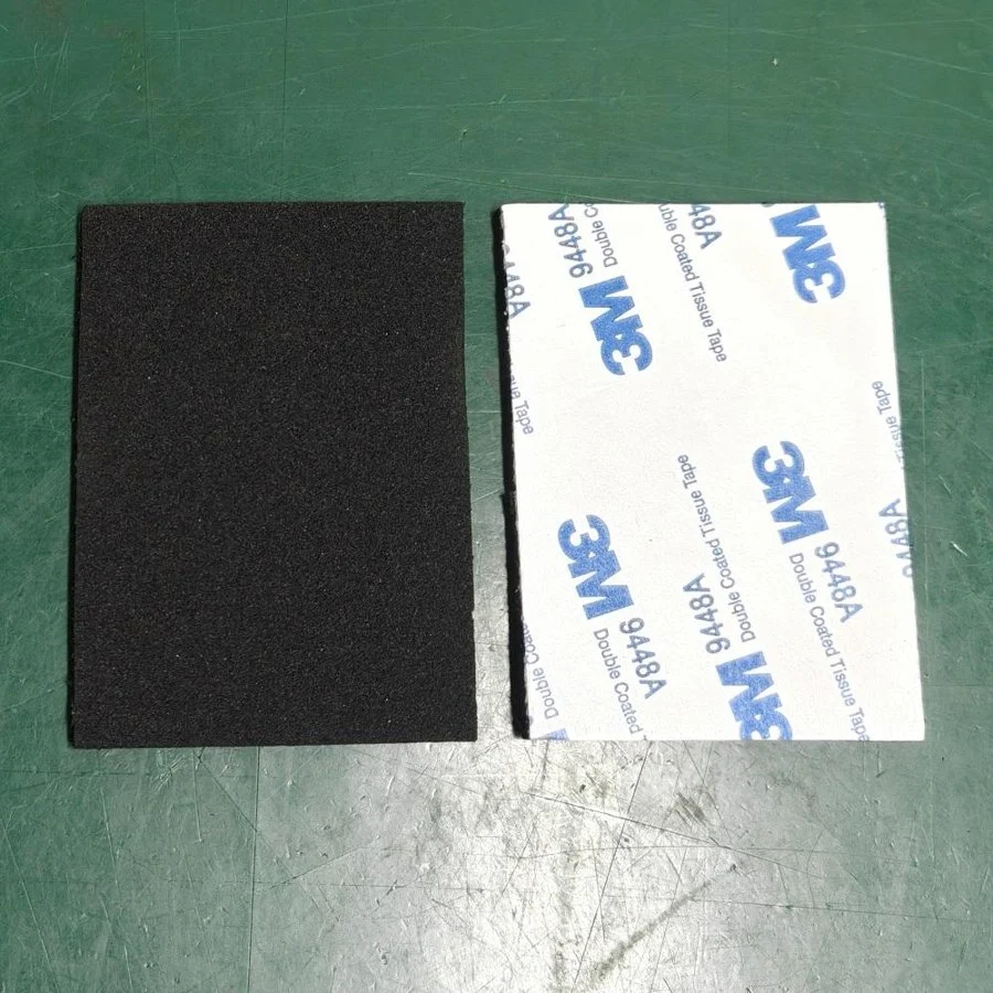 Black EPDM foam pad beside its adhesive liner
